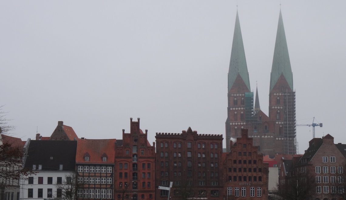 Stadsgezicht Lübeck met koophuizen en 2 spitse kerktorens